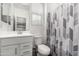 Clean, bright bathroom with patterned shower curtain and single vanity at 9901 E Tamery Ave, Mesa, AZ 85212
