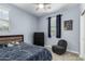 Comfortable bedroom with ceiling fan, window, and soft chair at 9901 E Tamery Ave, Mesa, AZ 85212