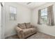 Cozy bedroom featuring a loveseat and two windows at 9901 E Tamery Ave, Mesa, AZ 85212