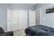 Blue bedroom featuring a closet and soft carpet at 9901 E Tamery Ave, Mesa, AZ 85212