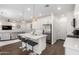 Modern kitchen featuring a center island with pendant lights, stainless steel appliances, and dark hardwood floors at 9901 E Tamery Ave, Mesa, AZ 85212