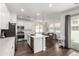 Well-lit kitchen with stainless steel appliances, a kitchen island, and an adjacent dining space at 9901 E Tamery Ave, Mesa, AZ 85212
