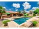 Luxurious backyard featuring a sparkling pool, bar area, and lush landscaping, perfect for outdoor entertaining and relaxation at 10105 E Larkspur Dr, Scottsdale, AZ 85260