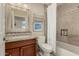 Traditional bathroom featuring a tub and shower combo, stylish granite countertop, and tile backsplash at 10105 E Larkspur Dr, Scottsdale, AZ 85260