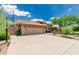 Charming home featuring a large garage, well-maintained landscaping, and a warm, inviting facade with a basketball hoop at 10105 E Larkspur Dr, Scottsdale, AZ 85260
