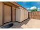 Exterior storage area next to the house featuring a door and corrugated metal, providing practical and secure space at 10105 E Larkspur Dr, Scottsdale, AZ 85260