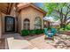 Cozy front porch with seating area, beautiful landscaping, and a charming entrance, perfect for enjoying the outdoors at 10105 E Larkspur Dr, Scottsdale, AZ 85260