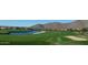 Scenic golf course view with a water hazard and mountain backdrop at 10105 E Larkspur Dr, Scottsdale, AZ 85260