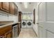 Bright laundry room features a washer, dryer, storage, and utility sink at 10105 E Larkspur Dr, Scottsdale, AZ 85260