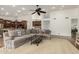 Spacious living room featuring a comfortable sectional sofa, ceiling fan, and open-concept design flowing into the kitchen at 10105 E Larkspur Dr, Scottsdale, AZ 85260