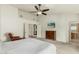 Comfortable main bedroom with neutral carpet, an ensuite bathroom, and a mounted television at 10105 E Larkspur Dr, Scottsdale, AZ 85260