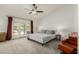 Bright main bedroom with carpeted floors, patio access, and a ceiling fan at 10105 E Larkspur Dr, Scottsdale, AZ 85260