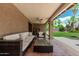 Covered patio area with ample seating, a coffee table, and ceiling fan at 10105 E Larkspur Dr, Scottsdale, AZ 85260