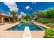 Backyard pool and dive board, surrounded by lush landscaping and lounge furniture at 10105 E Larkspur Dr, Scottsdale, AZ 85260