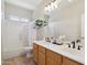 Bright bathroom featuring double sinks, a large mirror, and a shower-tub combination at 10448 E Conieson Rd, Scottsdale, AZ 85255
