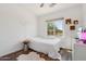 Inviting bedroom featuring a comfortable bed, hardwood floors, and lots of natural light at 10448 E Conieson Rd, Scottsdale, AZ 85255