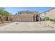 Two-story home boasts a three-car garage and desert landscaping at 10448 E Conieson Rd, Scottsdale, AZ 85255