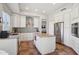 Kitchen featuring custom white cabinets, island, and stainless-steel appliances at 10448 E Conieson Rd, Scottsdale, AZ 85255