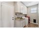 Functional laundry room with ample cabinet space, a granite sink, and modern appliances at 10448 E Conieson Rd, Scottsdale, AZ 85255