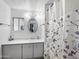 Neat bathroom with neutral decor featuring a framed mirror, modern lighting, and a stylish shower curtain at 120 N Val Vista Dr # 178, Mesa, AZ 85213