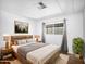 Cozy bedroom features a wooden bed frame, plush bedding, and ample natural light from the window at 120 N Val Vista Dr # 178, Mesa, AZ 85213