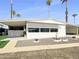 Charming single-story home with carport, palm trees, and desert landscaping offering a serene and inviting curb appeal at 120 N Val Vista Dr # 178, Mesa, AZ 85213