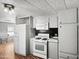 Well-lit kitchen featuring essential appliances, ample storage, and laminate flooring at 120 N Val Vista Dr # 178, Mesa, AZ 85213