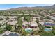 Expansive aerial view of desert community featuring homes with private pools, lush desert landscaping, and mountain views at 12183 E Mercer Ln, Scottsdale, AZ 85259