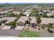 Aerial view of a desert home in a well-maintained community, showcasing its landscaping and proximity to amenities at 12183 E Mercer Ln, Scottsdale, AZ 85259