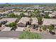 Aerial view of a desert home in a well-maintained community, showcasing its landscaping and proximity to amenities at 12183 E Mercer Ln, Scottsdale, AZ 85259