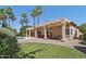 Expansive backyard with lush green lawn, desert landscaping, and a sparkling pool, ideal for outdoor enjoyment at 12183 E Mercer Ln, Scottsdale, AZ 85259