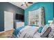 Bright bedroom features an oversized window, ceiling fan, and plenty of natural light at 12183 E Mercer Ln, Scottsdale, AZ 85259