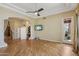Spacious bedroom with hardwood floors, ceiling fan, TV, and walk-in closet at 12183 E Mercer Ln, Scottsdale, AZ 85259