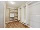 Well-organized walk-in closet featuring custom shelving and ample storage space at 12183 E Mercer Ln, Scottsdale, AZ 85259