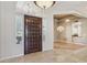 Welcoming entryway with a large wood door, tile floors, and views into the dining and living spaces at 12183 E Mercer Ln, Scottsdale, AZ 85259