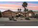 Charming desert home featuring mature palm trees, desert landscaping, three car garage and a welcoming front entry at 12183 E Mercer Ln, Scottsdale, AZ 85259