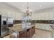 Spacious kitchen with a large island, granite countertops, stainless steel appliances, and custom cabinets at 12183 E Mercer Ln, Scottsdale, AZ 85259