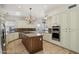 Bright, updated kitchen with stainless steel appliances, custom cabinets, and a granite-topped island at 12183 E Mercer Ln, Scottsdale, AZ 85259