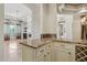 View of the open floor plan with granite countertop, white cabinets and view to the living space at 12183 E Mercer Ln, Scottsdale, AZ 85259