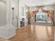 Open living room with a fireplace and large windows with view of a pool and palm trees at 12183 E Mercer Ln, Scottsdale, AZ 85259