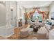 Spacious staged living room with hardwood floors, large window and decorative columns and trim at 12183 E Mercer Ln, Scottsdale, AZ 85259