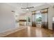 Open concept living space with hardwood floors and views of a modern kitchen and outdoor patio at 12183 E Mercer Ln, Scottsdale, AZ 85259