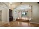 Bright living room with wood floors, columns, large windows, and modern chandelier at 12183 E Mercer Ln, Scottsdale, AZ 85259