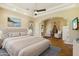 Bright and airy main bedroom featuring hardwood floors, a ceiling fan, and sitting area at 12183 E Mercer Ln, Scottsdale, AZ 85259