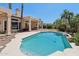 Stunning pool area with desert landscaping, palm trees, and a covered patio, perfect for outdoor living at 12183 E Mercer Ln, Scottsdale, AZ 85259