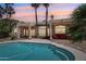 Beautiful pool with patio and rear exterior; large windows let in ample light in this desert home at 12183 E Mercer Ln, Scottsdale, AZ 85259