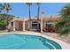 Beautiful pool and patio area offer a relaxing outdoor living space with desert landscaping and covered patio at 12183 E Mercer Ln, Scottsdale, AZ 85259