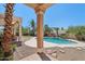 Picturesque backyard pool surrounded by desert landscaping and a covered patio, ideal for entertaining and relaxation at 12183 E Mercer Ln, Scottsdale, AZ 85259