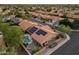 Stunning aerial view of a home featuring a refreshing pool, solar panels, and a well-maintained yard at 13361 N 99Th Pl, Scottsdale, AZ 85260