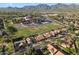 Expansive aerial view of a neighborhood highlighting the community, adjacent school, and distant mountains at 13361 N 99Th Pl, Scottsdale, AZ 85260